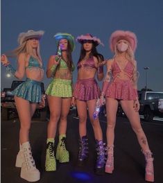 three women in short skirts and hats standing next to each other