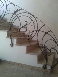 a set of stairs with wrought iron handrails