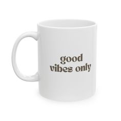 a white coffee mug that says good vibes only