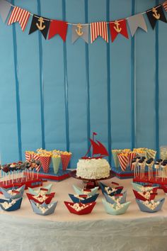 a table topped with lots of cupcakes and cakes