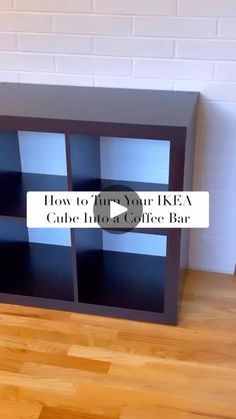 a black bookcase sitting on top of a wooden floor