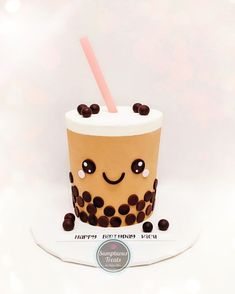 there is a cake shaped like a coffee cup with a straw in it and chocolate chips on the side