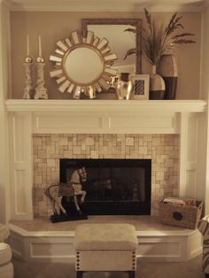 a living room with a fire place and mirror on the wall above it's mantle