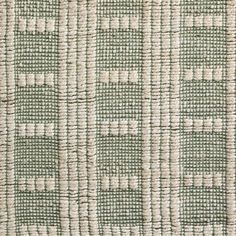 a close up view of a green and white rug