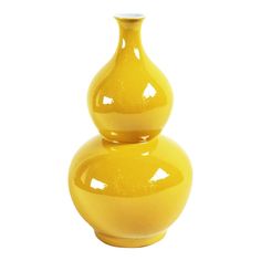 two yellow vases sitting on top of each other