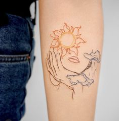 a woman's arm with a tattoo on it and the sun above her head