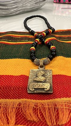 Black 10mm wood beads with Rasta colours and pave crystals hangs approximately 34 inch with a solid brass gold pendant of his majesty Haile Selassie Haile Selassie, Rasta Colors, Hair Pack, Spice Recipes, Shell Necklace, Brass Gold, Shell Necklaces, Chain Styles, Wood Beads