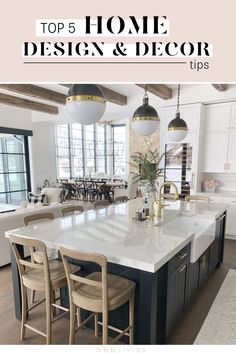 a large kitchen with an island in the middle and two pendant lights hanging from the ceiling