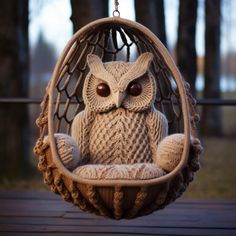 an owl knitted in a hammock hanging from a chain