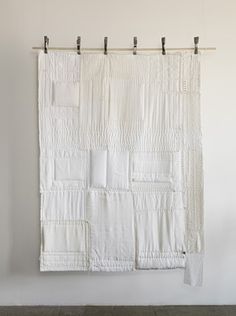 a white wall hanging on the side of a wall