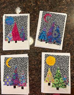 four pictures with different designs on them sitting on a counter top next to each other