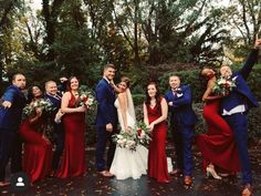 a group of people standing next to each other in front of trees and bushes with flowers on their heads