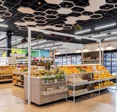 an empty grocery store filled with lots of fresh fruits and veggies on display