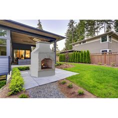 an outdoor fireplace in the middle of a yard