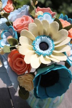 a bouquet of flowers sitting on top of a wooden table