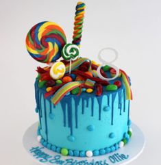 a birthday cake decorated with candy and lollipops