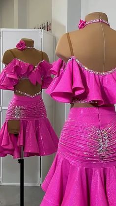 two dresses on mannequins, one in pink and the other in purple