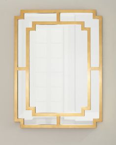 a gold framed mirror on the wall