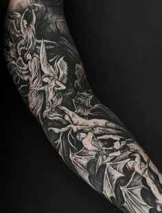 a man's arm covered in black and white tattoos