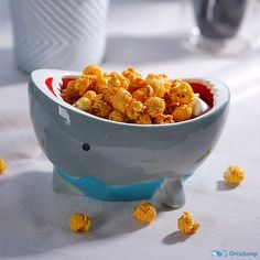 a bowl filled with popcorn sitting on top of a table