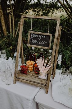 a wooden crate with drinks and strawberries on it sitting next to a sign that says pump your prosciuo