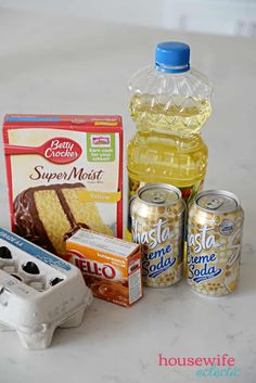 ingredients to make cake sitting on top of a white counter next to an egg carton