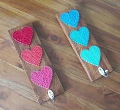 crocheted hearts hang on wood with keychain clippings in the shape of heart