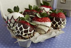 chocolate covered strawberries sit in a tray on a table