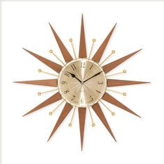 a gold and brown clock on a white background