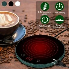 an electronic stove top sitting next to coffee beans