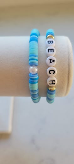 two bracelets that say beach and bead together on each one with beads attached to them