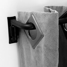 black and white photograph of eyeglasses hanging on towel rack