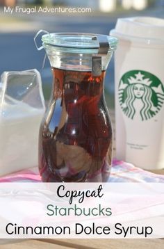 a glass jar filled with cinnamon dolce syrup sitting on top of a table