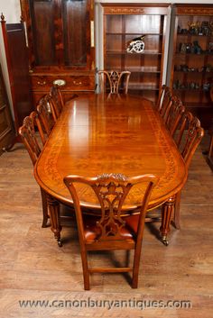 a large wooden table with chairs around it in a room filled with other wood furniture