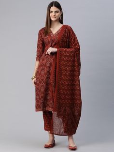 Women Floral Printed Regular Pure Cotton Kurta with Trousers & With Dupatta PRODUCT DETAILS  Red printed Kurta with Trousers with dupatta Kurta design: Floral printed Straight shape Regular style V-neck, three-quarter regular sleeves Zari detail Calf length length with straight hem Pure cotton machine weave fabric Trousers design: Printed Trousers Elasticated waistband Drawstring closure Size & Fit Size worn by the model: S Chest: 32" Waist: 29" Hips: 38" Height: 5'8" Material & Care Kurta Fabric: Cotton Bottom Fabric: Cotton Dupatta Fabric: Cotton Wash Care: Machine Wash Specifications Sleeve Length Three-Quarter Sleeves Top Shape Straight Top Type Kurta Bottom Type Trousers Dupatta With Dupatta Top Pattern Printed Top Design Styling Regular Top Hemline Straight Top Length Calf Length Nec Red Traditional Drape Sets With Printed Motifs, Red Sets With Printed Motifs In Traditional Drape, Red Sets With Printed Motifs And Traditional Drape, Fitted Red Bandhani Print Palazzo Set, Red Cotton Palazzo Set With Traditional Drape, Red Printed Kurta For Festive Occasions, Festive Red Printed Kurta, Red Printed Festive Sets, Red Sets With Printed Border For Eid