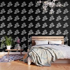 a black and white photo of a bedroom with a bed, chandelier and rug