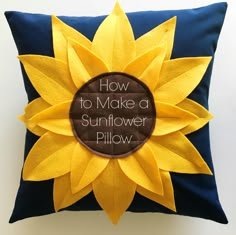 a pillow with a sunflower on the front and brown center piece in the middle