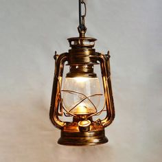 an old fashioned light hanging from a chain