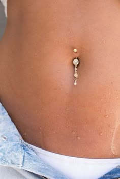 a woman's stomach with a piercing on it