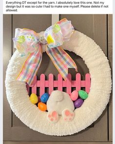 a wreath with an easter bunny on it and some candy in front of the door