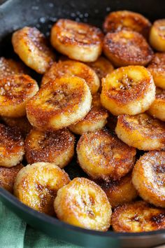 a pan filled with bananas sitting on top of a table