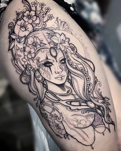 a woman's face with flowers on her thigh