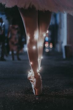 a ballerina's feet with lights on them