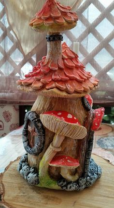 a mushroom house is sitting on top of a tree stump