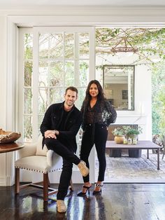 a man and woman sitting on a couch in a living room