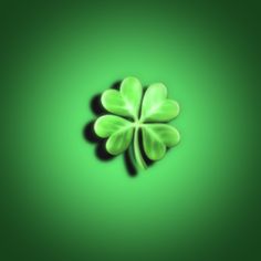 a four leaf clover is shown on a green background with the shadow of it's leaves