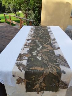 a white table cloth with an image of a woman on it sitting on a deck