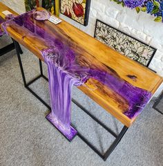 a wooden table with purple paint on it