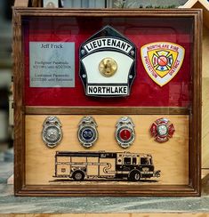 a display case with various badges on the front and back of it, including a fire truck