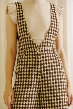 Houndstooth tweed wide legs palazzo jumpsuit. It features a deep U neckline, fitted at the waist, and belt loops with a center pearl button. It also has side pockets and double-welt back pockets. 100% Polyester Bust Waist Hips Inseam Length Small 30 inches 28 inches 40 inches 27 inches 54 inches Medium 32 inches 30 inches 42 inches 27 inches 54 inches Large 34 inches 32 inches 44 inches 27 inches 55 inches We measure each item from side seam to side seam, on a flat surface. Please consider the f Chic Overalls With Button Closure For Workwear, Chic Workwear Overalls With Button Closure, Chic Fall Overalls For Workwear, Chic Fall Workwear Overalls, Tweed Jumpsuit, Chic Belt, Palazzo Jumpsuit, Mode Inspo, Look Vintage